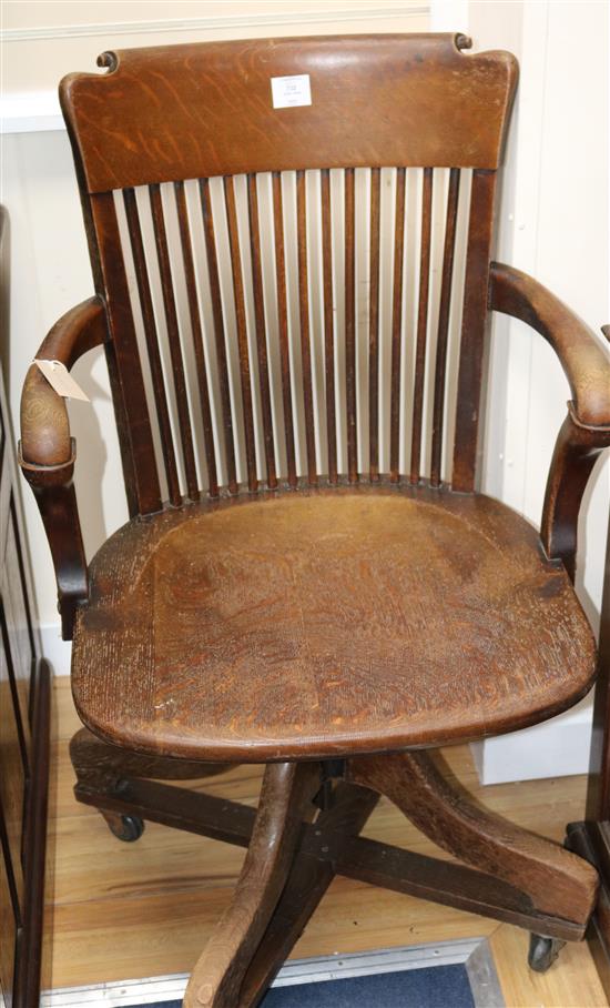 An Edwardian oak revolving desk chair